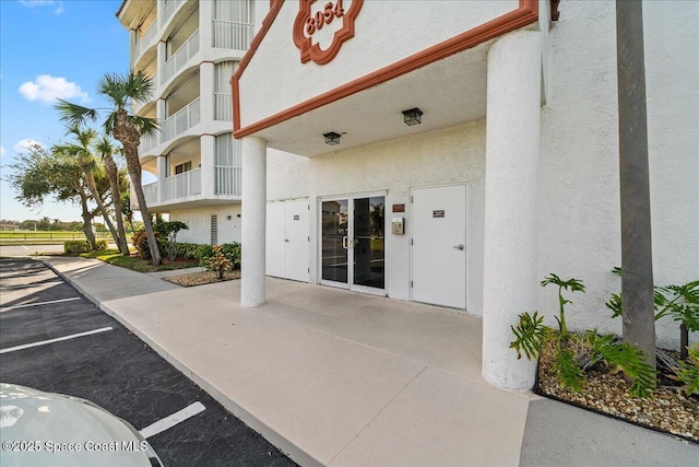 8954 Puerto Del Rio Dr Unit 1503, Cape Canaveral, FL 32920 - property entrance with stucco siding and uncovered parking