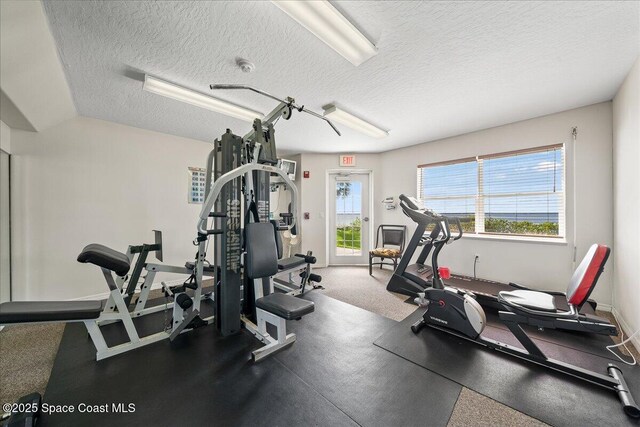 8954 Puerto Del Rio Dr Unit 1503, Cape Canaveral, FL 32920 - exercise room featuring a textured ceiling