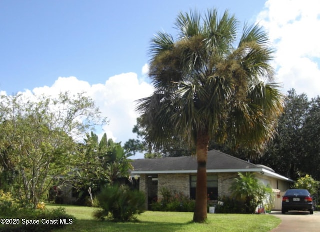 698 Awin Ct SE, Palm Bay, FL 32909 - ranch-style home with a front yard and concrete driveway