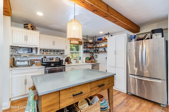 406 Mcleod Dr, Cocoa, FL 32922 - kitchen with stainless steel appliances, open shelves, white cabinets, beamed ceiling, and light wood-type flooring