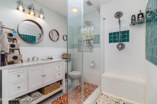 406 Mcleod Dr, Cocoa, FL 32922 - full bathroom featuring a shower stall, tile walls, vanity, and wainscoting