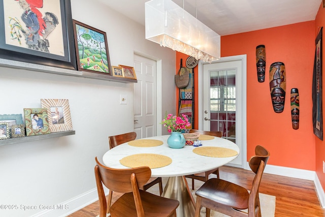 406 Mcleod Dr, Cocoa, FL 32922 - dining room with light wood-type flooring and baseboards
