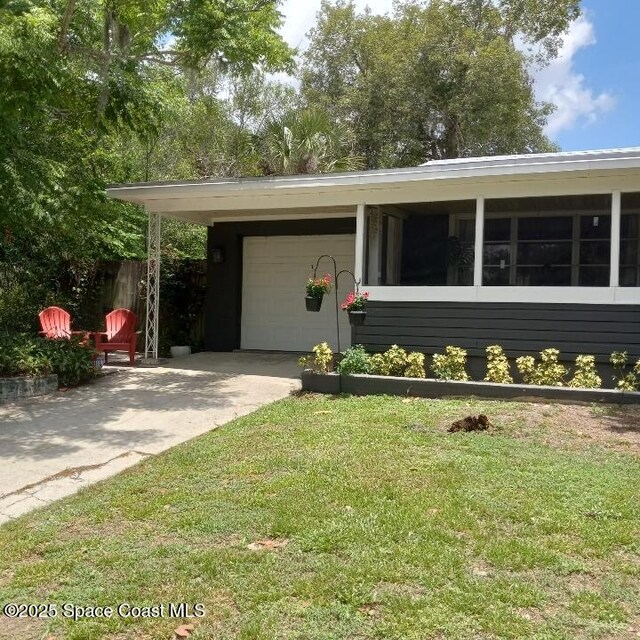 406 Mcleod Dr, Cocoa, FL 32922 - view of front of house featuring concrete driveway and a front yard
