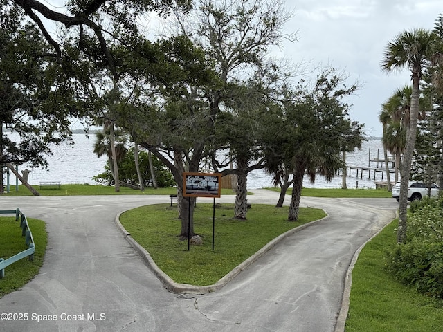 406 Mcleod Dr, Cocoa, FL 32922 - view of community with a water view, a yard, and curved driveway