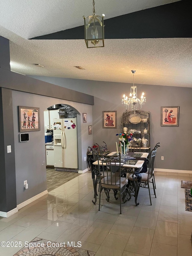 561 Plumbago Rd NW, Palm Bay, FL 32907 - dining space with a chandelier, a textured ceiling, and lofted ceiling
