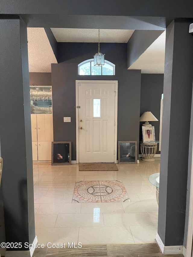 561 Plumbago Rd NW, Palm Bay, FL 32907 - entrance foyer featuring lofted ceiling and tile patterned flooring