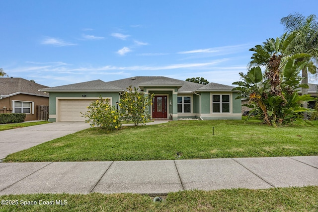 2542 Woodfield Cir, Melbourne, FL 32904 - view of front facade with stucco siding, concrete driveway, a garage, and a front lawn