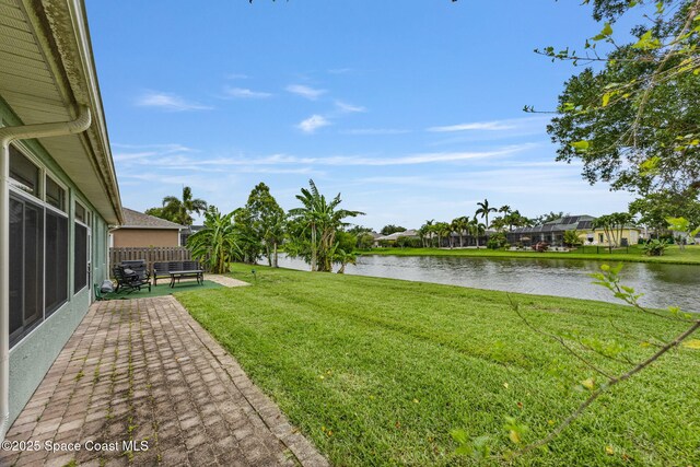2542 Woodfield Cir, Melbourne, FL 32904 - view of yard featuring a water view and a patio