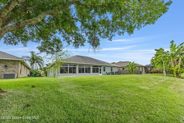 2542 Woodfield Cir, Melbourne, FL 32904 - view of green lawn with a sunroom