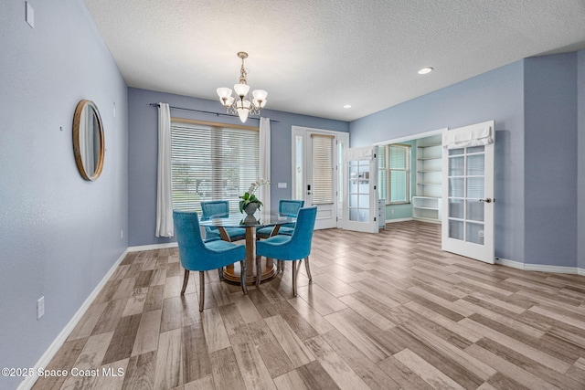 2542 Woodfield Cir, Melbourne, FL 32904 - dining room with a textured ceiling, a chandelier, wood finished floors, and recessed lighting