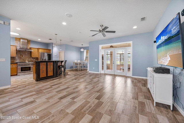 2542 Woodfield Cir, Melbourne, FL 32904 - kitchen with stainless steel appliances, extractor fan, ceiling fan, decorative backsplash, and french doors