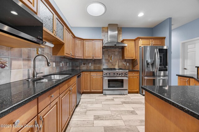 2542 Woodfield Cir, Melbourne, FL 32904 - kitchen with stainless steel appliances, wall chimney range hood, backsplash, dark stone counters, and brown cabinetry