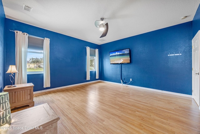 2542 Woodfield Cir, Melbourne, FL 32904 - empty room with wood finished floors and a textured wall