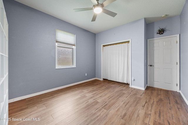 2542 Woodfield Cir, Melbourne, FL 32904 - unfurnished bedroom with wood finished floors, a closet, and a ceiling fan