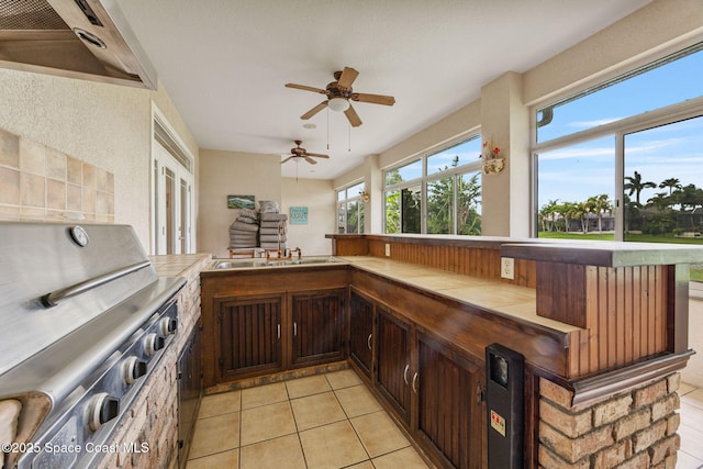 2542 Woodfield Cir, Melbourne, FL 32904 - bar with light tile patterned floors, a ceiling fan, and range hood