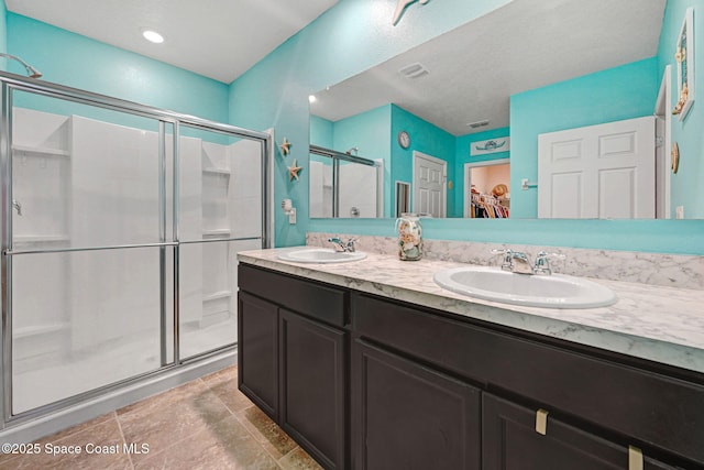 6586 Split Rail Ln, Cocoa, FL 32927 - bathroom featuring a stall shower, double vanity, and a walk in closet