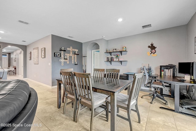 6586 Split Rail Ln, Cocoa, FL 32927 - dining area featuring arched walkways, recessed lighting, light tile patterned floors, and a desk