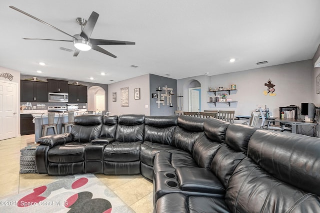 6586 Split Rail Ln, Cocoa, FL 32927 - living area with arched walkways, a ceiling fan, recessed lighting, and light tile patterned flooring