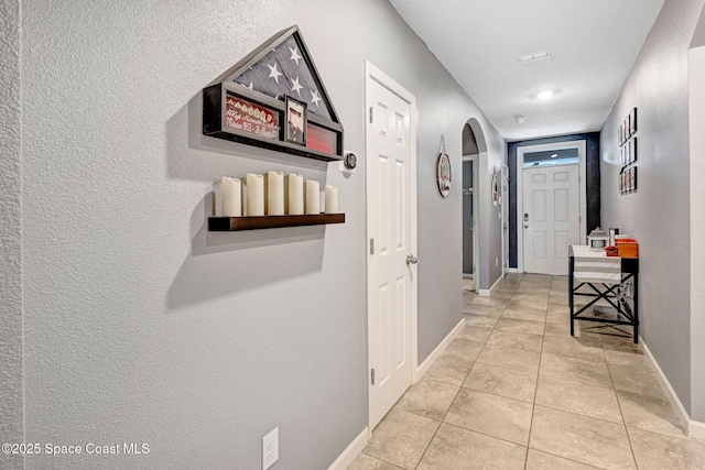 6586 Split Rail Ln, Cocoa, FL 32927 - hall with light tile patterned flooring and arched walkways