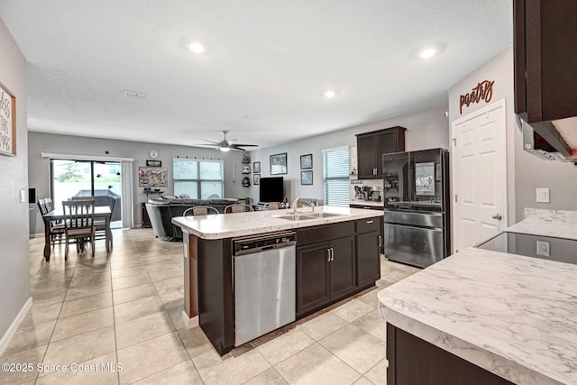 6586 Split Rail Ln, Cocoa, FL 32927 - kitchen with appliances with stainless steel finishes, light countertops, a ceiling fan, a center island with sink, and dark brown cabinets