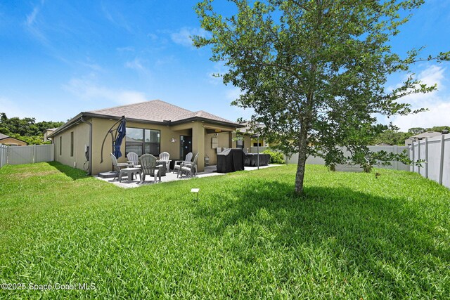 6586 Split Rail Ln, Cocoa, FL 32927 - back of property with a fenced backyard, stucco siding, a patio area, and an outdoor living space