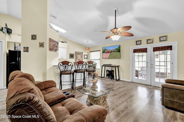 5505 95th St, Sebastian, FL 32958 - living room featuring vaulted ceiling, a ceiling fan, wood finished floors, french doors, and a textured ceiling