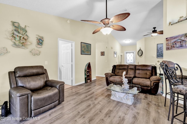 5505 95th St, Sebastian, FL 32958 - living room with a ceiling fan, wood finished floors, and high vaulted ceiling