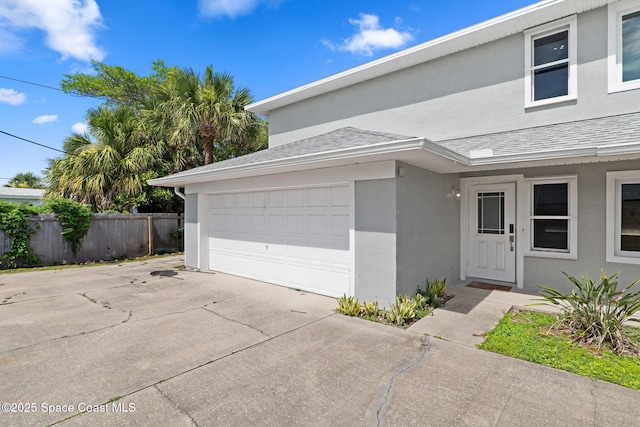120 Norwood Ave Unit 120, Satellite Beach, FL 32937 - view of front of home with stucco siding, driveway, and a garage