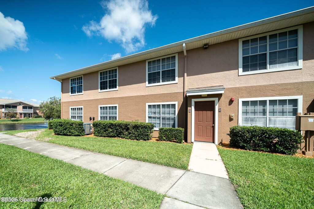 1880 Long Iron Dr Unit 1322, Rockledge, FL 32955 - view of property featuring stucco siding and a front lawn