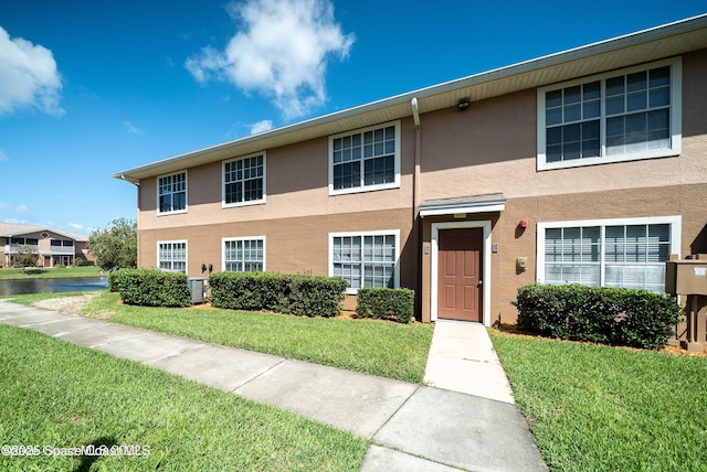 1880 Long Iron Dr Unit 1322, Rockledge, FL 32955 - view of property featuring stucco siding and a front lawn