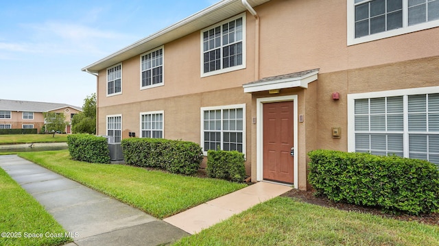 1880 Long Iron Dr Unit 1322, Rockledge, FL 32955 - view of front facade with stucco siding and a front lawn