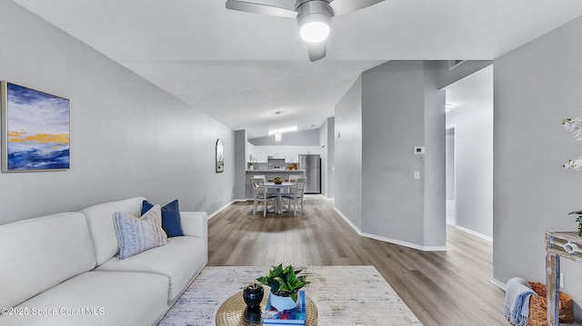 1880 Long Iron Dr Unit 1322, Rockledge, FL 32955 - living room with wood finished floors, ceiling fan, and vaulted ceiling