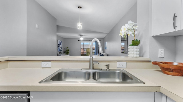 1880 Long Iron Dr Unit 1322, Rockledge, FL 32955 - kitchen featuring light countertops, vaulted ceiling, white cabinetry, and pendant lighting