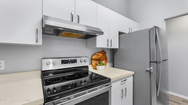 1880 Long Iron Dr Unit 1322, Rockledge, FL 32955 - kitchen featuring stainless steel appliances, exhaust hood, light countertops, white cabinetry, and light wood-style floors