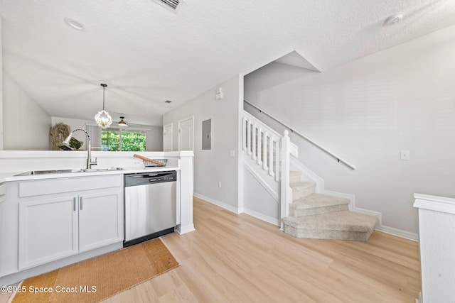 1311 Hampton Park Ln, Melbourne, FL 32940 - kitchen featuring dishwasher, light wood finished floors, a textured ceiling, light countertops, and pendant lighting