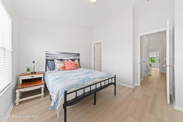 1311 Hampton Park Ln, Melbourne, FL 32940 - bedroom featuring light wood-style flooring and a towering ceiling