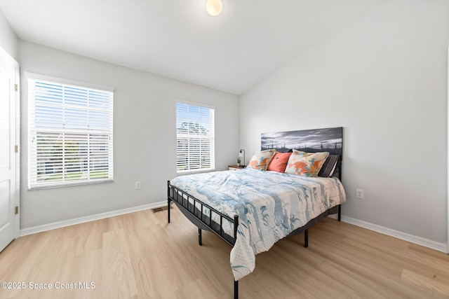 1311 Hampton Park Ln, Melbourne, FL 32940 - bedroom with light wood-type flooring and vaulted ceiling