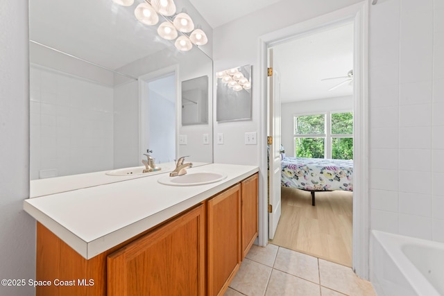 1311 Hampton Park Ln, Melbourne, FL 32940 - bathroom with vanity, tile patterned flooring, connected bathroom, and a ceiling fan