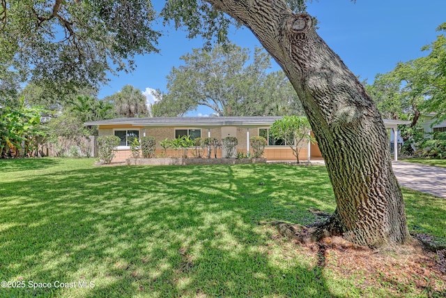 955 Samar Rd, Cocoa Beach, FL 32931 - view of front of property featuring a front lawn and brick siding