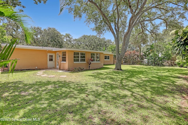 955 Samar Rd, Cocoa Beach, FL 32931 - rear view of house featuring stucco siding