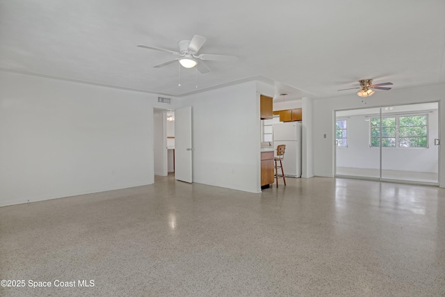 955 Samar Rd, Cocoa Beach, FL 32931 - unfurnished living room with ceiling fan and dark aggregate flooring