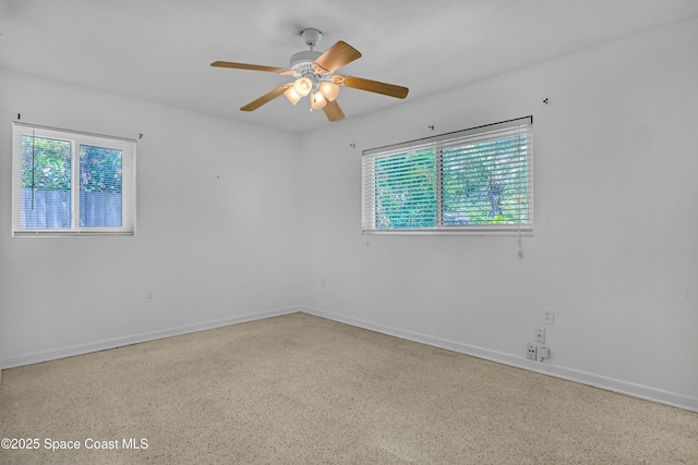 955 Samar Rd, Cocoa Beach, FL 32931 - unfurnished room with plenty of natural light, speckle patterned floor, and a ceiling fan