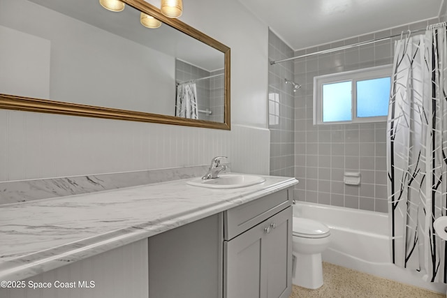 955 Samar Rd, Cocoa Beach, FL 32931 - bathroom with vanity, shower / bath combination with curtain, wainscoting, and speckled floor