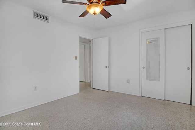 955 Samar Rd, Cocoa Beach, FL 32931 - unfurnished bedroom featuring speckle patterned floor, a closet, and a ceiling fan