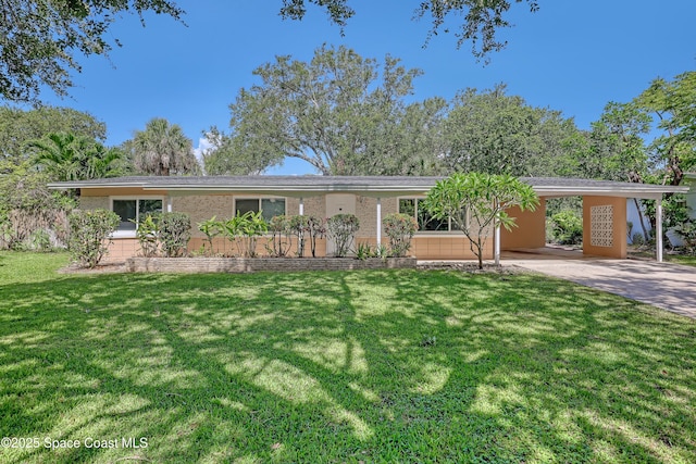955 Samar Rd, Cocoa Beach, FL 32931 - ranch-style house with an attached carport, a front lawn, brick siding, and driveway