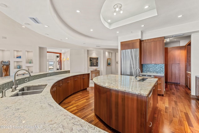 2375 S Atlantic Ave Unit 601, Cocoa Beach, FL 32931 - kitchen with modern cabinets, stainless steel refrigerator, wood finished floors, a large island, and recessed lighting