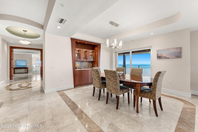 2375 S Atlantic Ave Unit 601, Cocoa Beach, FL 32931 - dining area featuring a raised ceiling, inlaid floor details, recessed lighting, and a chandelier