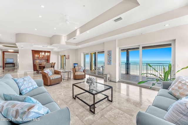 2375 S Atlantic Ave Unit 601, Cocoa Beach, FL 32931 - living room with a water view, recessed lighting, plenty of natural light, ceiling fan, and a chandelier