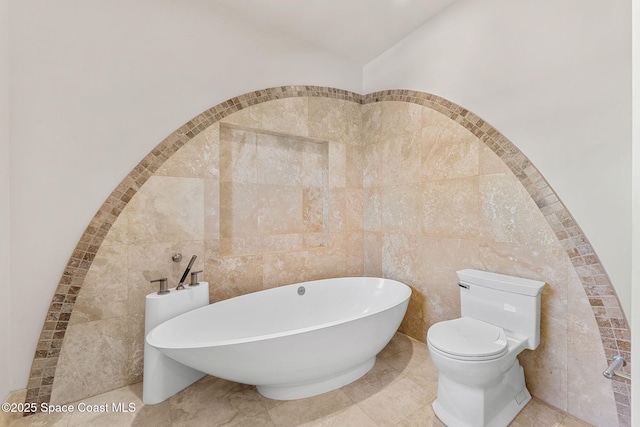 2375 S Atlantic Ave Unit 601, Cocoa Beach, FL 32931 - bathroom featuring tile walls and a freestanding bath