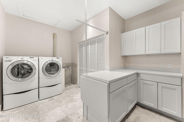 2375 S Atlantic Ave Unit 601, Cocoa Beach, FL 32931 - laundry area featuring washer and dryer, cabinet space, and attic access